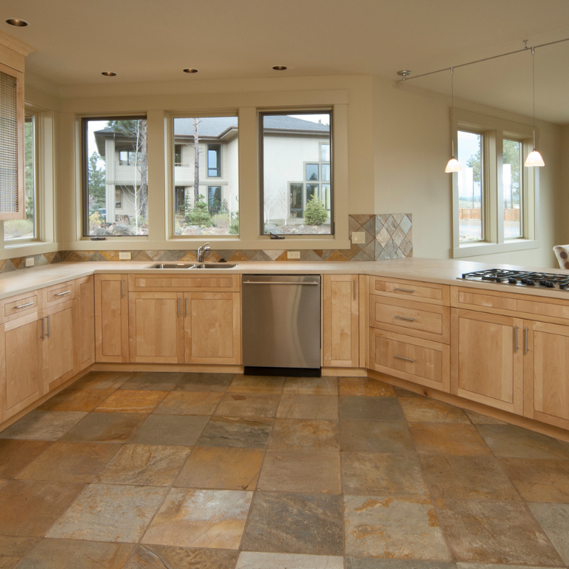 a kitchen with wooden cabinets and a stainless steel dishwasher